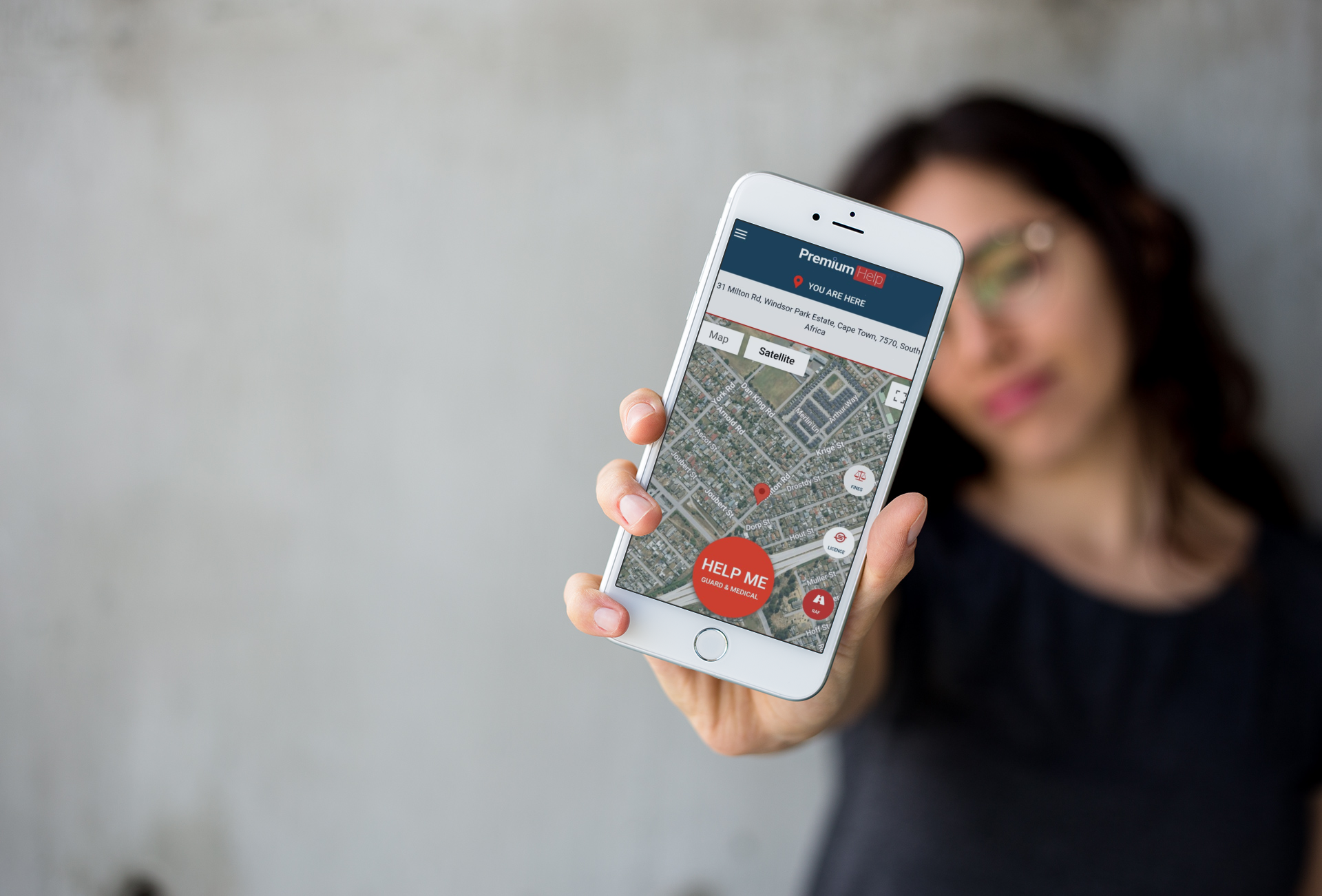 Customer holding the All Road Premium Help app showing the live map and panic button